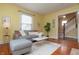 Bright living room with a plush sofa, hardwood floors, and access to the upper level at 5915 Lowell Ave, Indianapolis, IN 46219