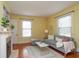 Cozy living room featuring a decorative fireplace, hardwood floors, and ample natural light at 5915 Lowell Ave, Indianapolis, IN 46219