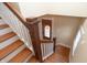 View of the wooden staircase with white risers leading down to the front door, providing a glimpse of the home's entryway at 5915 Lowell Ave, Indianapolis, IN 46219