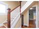 Classic staircase with hardwood steps and white railing, leading to the upper level at 5915 Lowell Ave, Indianapolis, IN 46219