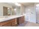 Bright bathroom with walk in tub/shower, dual sink vanity, and walk-in shower with glass door at 607 N White Ash N Ct, Mooresville, IN 46158