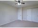 Neutral bedroom featuring carpet, ceiling fan, and closets for plenty of storage at 607 N White Ash N Ct, Mooresville, IN 46158