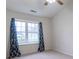 Bedroom featuring neutral carpet, ceiling fan, and natural light from a large window at 607 N White Ash N Ct, Mooresville, IN 46158