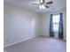 Bedroom features neutral carpet, ceiling fan, and natural light from a large window at 607 N White Ash N Ct, Mooresville, IN 46158