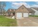 Charming brick home featuring an attached two-car garage, well-manicured lawn, and inviting curb appeal at 607 N White Ash N Ct, Mooresville, IN 46158