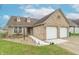 Brick home with a two-car garage, front yard featuring manicured landscaping, and a welcoming walkway at 607 N White Ash N Ct, Mooresville, IN 46158