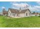 Exterior view of the home highlighting the covered patio and well-kept lawn at 607 N White Ash N Ct, Mooresville, IN 46158
