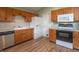Well-lit kitchen features stainless steel appliances, warm wood cabinetry, and a refrigerator with water dispenser at 607 N White Ash N Ct, Mooresville, IN 46158