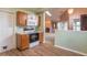 Compact kitchen featuring wood cabinets, a range, microwave, a skylight, and open view to adjacent living room at 607 N White Ash N Ct, Mooresville, IN 46158