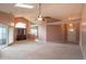 Bright living room with high ceilings, ceiling fan, neutral walls, and large windows providing ample natural light at 607 N White Ash N Ct, Mooresville, IN 46158
