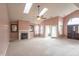 Spacious living room featuring skylights, fireplace, ceiling fan, and sliding glass door to the backyard at 607 N White Ash N Ct, Mooresville, IN 46158