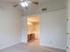 Bright bedroom featuring neutral carpet, ceiling fan, and an ensuite bathroom with dual sinks at 607 N White Ash N Ct, Mooresville, IN 46158
