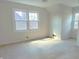 Bright, neutral bedroom with carpeted floors and large windows offering an abundance of natural light at 6105 E St Joseph St, Indianapolis, IN 46219