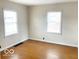 Simple bedroom with natural light coming through two windows and hardwood floors at 6105 E St Joseph St, Indianapolis, IN 46219
