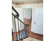 Inviting entryway featuring hardwood floors, classic trim, and an elegant wrought iron staircase at 6105 E St Joseph St, Indianapolis, IN 46219