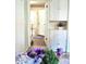 Bright hallway with white cabinets, leading to living spaces, and adorned with charming purple floral accents at 6105 E St Joseph St, Indianapolis, IN 46219
