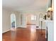 Spacious living room with hardwood floors, arched doorways, and fireplace showcasing character at 6105 E St Joseph St, Indianapolis, IN 46219