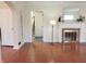 Bright living room featuring a fireplace, hardwood floors, and arched doorways for a classic style at 6105 E St Joseph St, Indianapolis, IN 46219