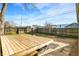View of a large wooden backyard deck with a built in bench at 621 Melvenia St, Indianapolis, IN 46219