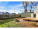 View of a backyard with a stone fire pit, a wooden deck, and a green detached garage at 621 Melvenia St, Indianapolis, IN 46219