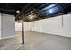 Unfinished basement with concrete floor, open ceiling, painted walls, and support beam at 621 Melvenia St, Indianapolis, IN 46219