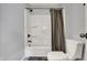 Bathroom with a shower and tub featuring bronze fixtures, and a white toilet at 621 Melvenia St, Indianapolis, IN 46219