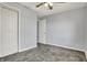 A bedroom with carpet flooring, ceiling fan, closet, and a white door at 621 Melvenia St, Indianapolis, IN 46219