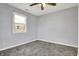 Neutral bedroom with a carpeted floor, bright window, ceiling fan, and fresh paint at 621 Melvenia St, Indianapolis, IN 46219