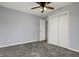 Bedroom featuring a neutral color scheme, a ceiling fan, plush carpeting, and a double door closet at 621 Melvenia St, Indianapolis, IN 46219