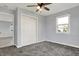 Neutral bedroom featuring a ceiling fan, closet, and window with outside view with plush carpeting at 621 Melvenia St, Indianapolis, IN 46219