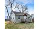 Charming single-story home featuring a small front porch and light green siding on a sunny day at 621 Melvenia St, Indianapolis, IN 46219