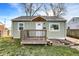 Quaint single-story home with light green siding, a front porch, and a manicured lawn at 621 Melvenia St, Indianapolis, IN 46219