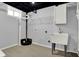Utility room with white utility sink, cabinet, open ceiling, and light gray walls at 621 Melvenia St, Indianapolis, IN 46219