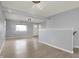 Open-concept living area with neutral paint, laminate floors, and natural light coming through the window at 621 Melvenia St, Indianapolis, IN 46219