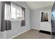 A view of the mud room featuring tile floors, white walls, a window, and a door at 621 Melvenia St, Indianapolis, IN 46219