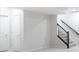 Spacious basement featuring carpeted stairs with metal railing, two closets with white doors at 6609 N Dogwood Dr, McCordsville, IN 46055