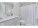 Modern bathroom with a white vanity, quartz countertop and a shower with a white curtain at 6609 N Dogwood Dr, McCordsville, IN 46055