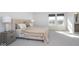 Bright bedroom with large bed, neutral tones, and natural light from the window, creating a relaxing atmosphere at 6609 N Dogwood Dr, McCordsville, IN 46055
