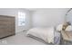 Comfortable bedroom with large window providing natural light, soft carpet, and side table with drawers at 6609 N Dogwood Dr, McCordsville, IN 46055