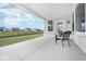 Spacious covered patio with concrete flooring and a chair, overlooking the backyard at 6609 N Dogwood Dr, McCordsville, IN 46055