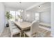 Bright dining room featuring a modern chandelier, large windows, and an open floor plan at 6609 N Dogwood Dr, McCordsville, IN 46055
