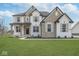 Beautiful two-story home featuring stone accents, black roof, and a well-maintained front yard at 6609 N Dogwood Dr, McCordsville, IN 46055