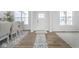 Bright and airy foyer featuring wood floors, white walls, and a view to the dining room at 6609 N Dogwood Dr, McCordsville, IN 46055