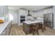 Beautiful kitchen featuring stainless steel appliances, a center island, and hardwood flooring at 6609 N Dogwood Dr, McCordsville, IN 46055