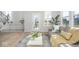 Bright living room featuring wood floors, modern furniture, and natural light pouring in from windows at 6609 N Dogwood Dr, McCordsville, IN 46055