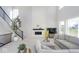 Living room with soaring ceilings, black and metal staircase, and modern fireplace at 6609 N Dogwood Dr, McCordsville, IN 46055