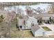 An aerial view shows the home's proximity to the water, detached garage, and the surrounding green spaces at 7160 Harbour, Indianapolis, IN 46240