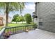 Backyard patio offering views of grassy lawn, mature trees, and neighboring waterfront homes at 7160 Harbour, Indianapolis, IN 46240