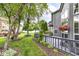 Relaxing backyard with mature trees, views of neighboring properties, and outdoor deck at 7160 Harbour, Indianapolis, IN 46240