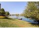 Backyard view featuring a lakeside with lawn, a dock and a yellow kayak at 7160 Harbour, Indianapolis, IN 46240
